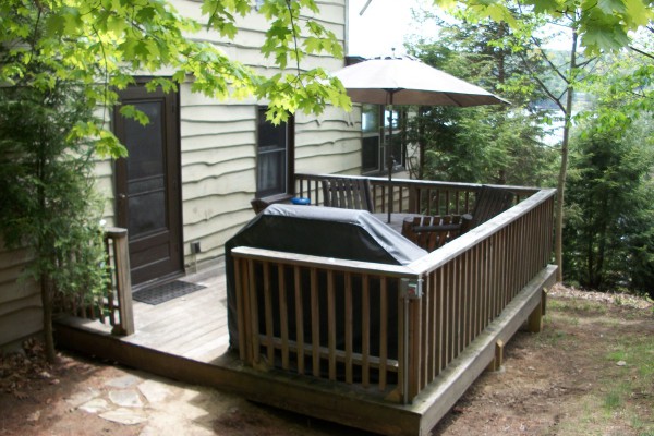 rear deck with grill, seating and umbrella