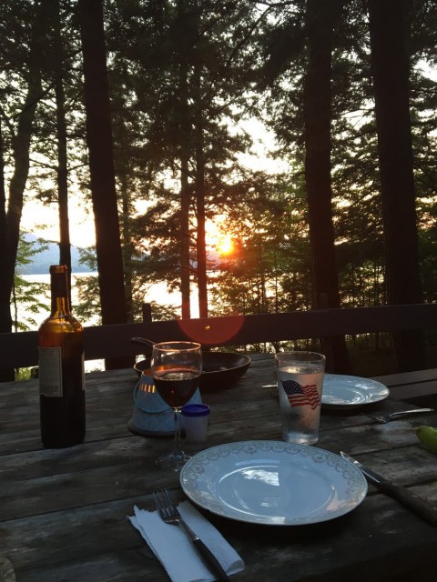 View from the deck picnic table to the lake at sunset 