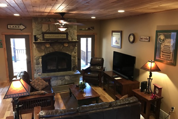 Living room with wood burning stone fireplace
