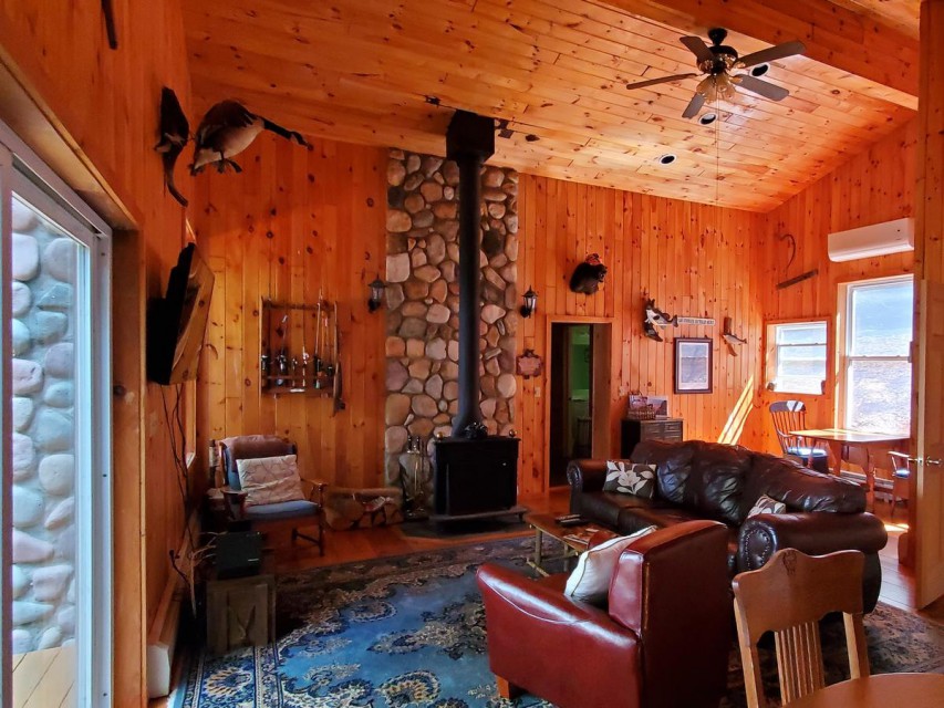Main living area with wood stove and laundry room