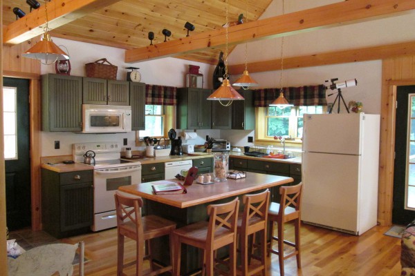 Open airy well-stocked kitchen & eating Island