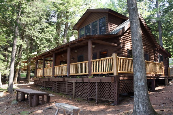 View of cabin from waterfront; picnic bench in front