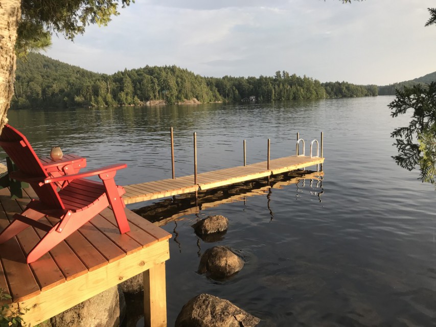 A new dock and deck with Adirondack chairs