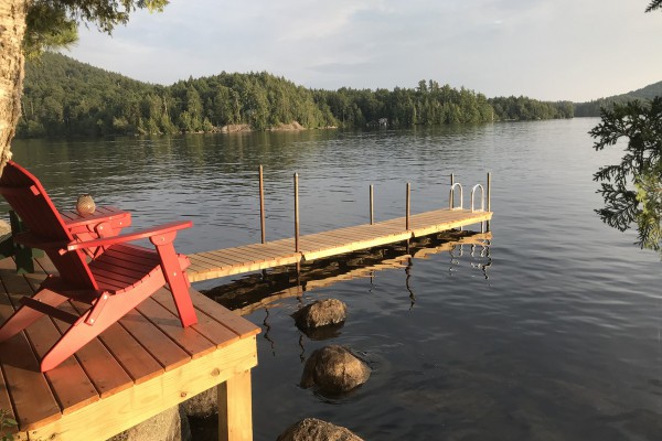 A new dock and deck with Adirondack chairs