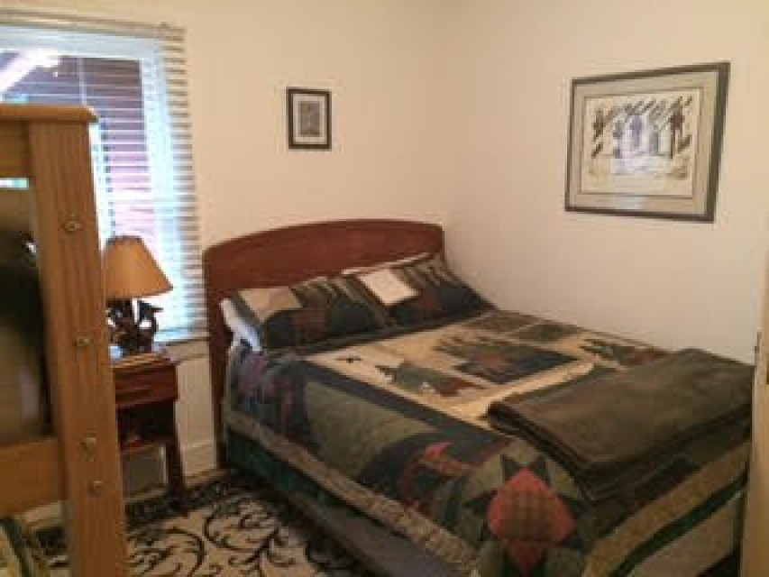 First floor bedroom, queen bed and bunk beds