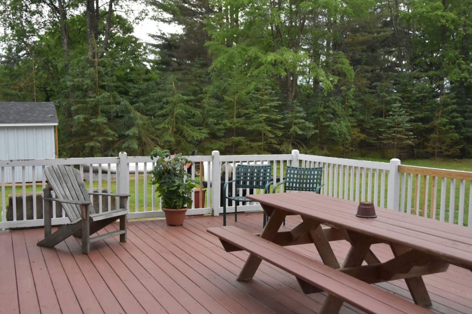 large deck with 9ft picnic table, grill, seating area